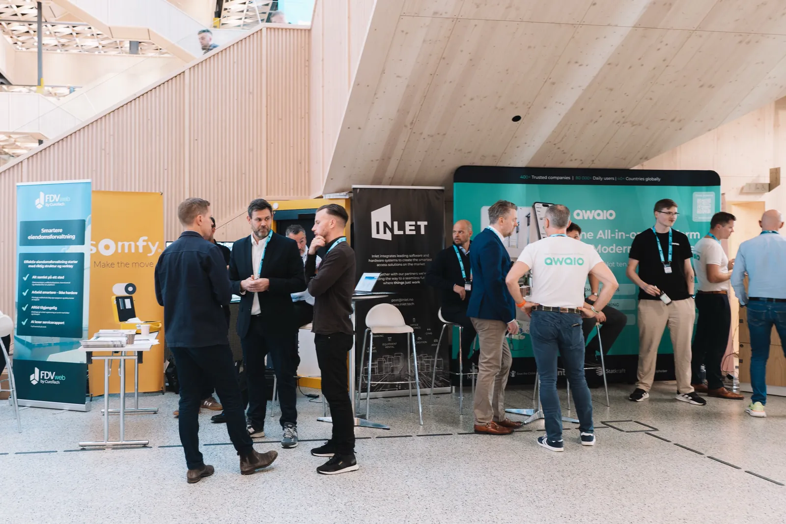 Visitors talking with the Awaio team at the Awaio stand at Oslo Proptech Summit 2026