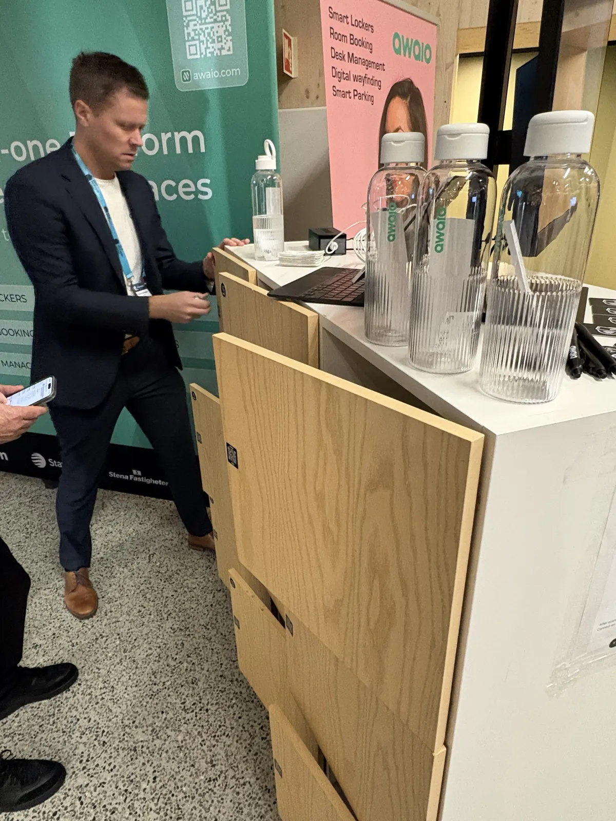 A visitor trying the Awaio smart locker demo, opening a locker with a phone