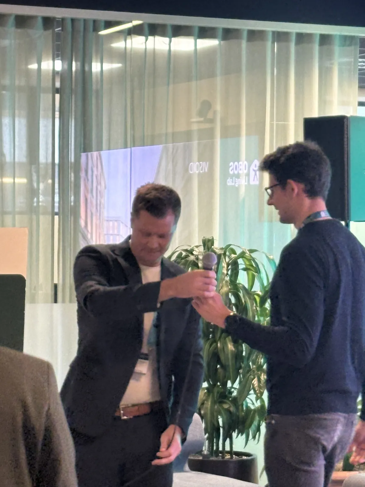 Speakers handing over the microphone on the Future of Work & Life stage