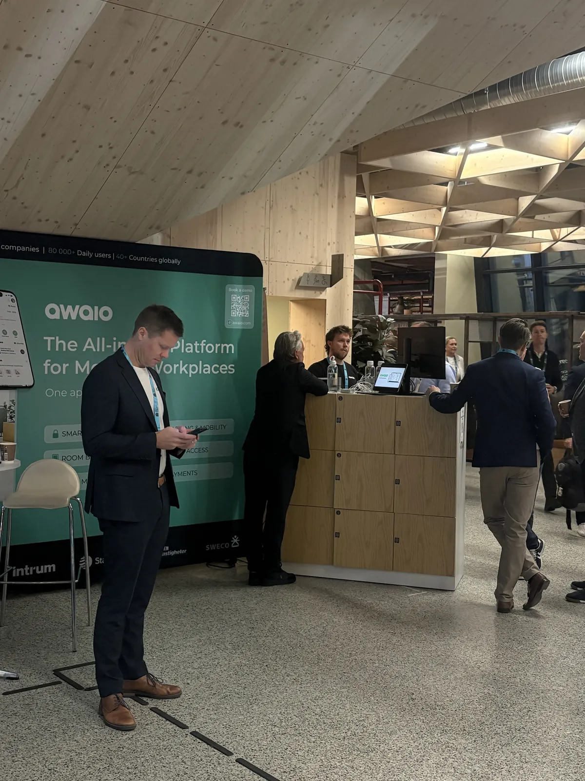Visitors at the Awaio stand next to the smart locker demo