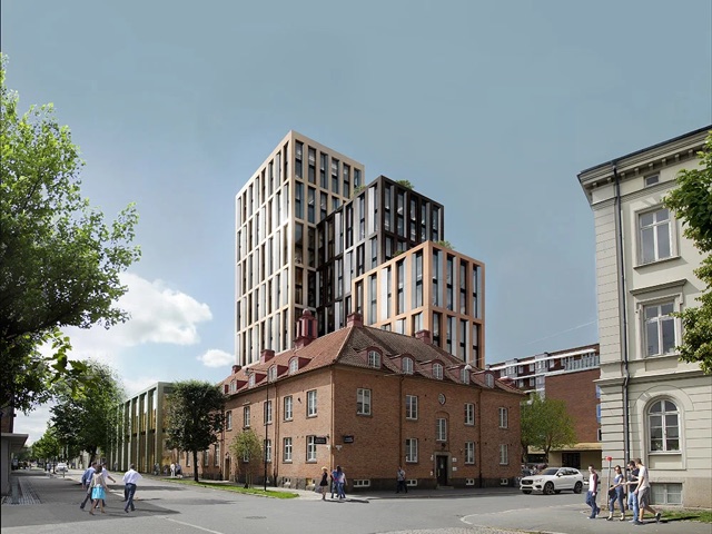 Modern office tower above a historic brick building on a city street