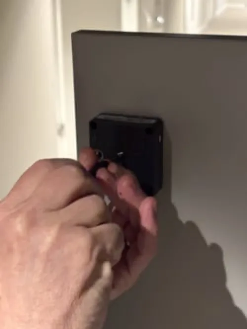 Screw the battery latch back in place